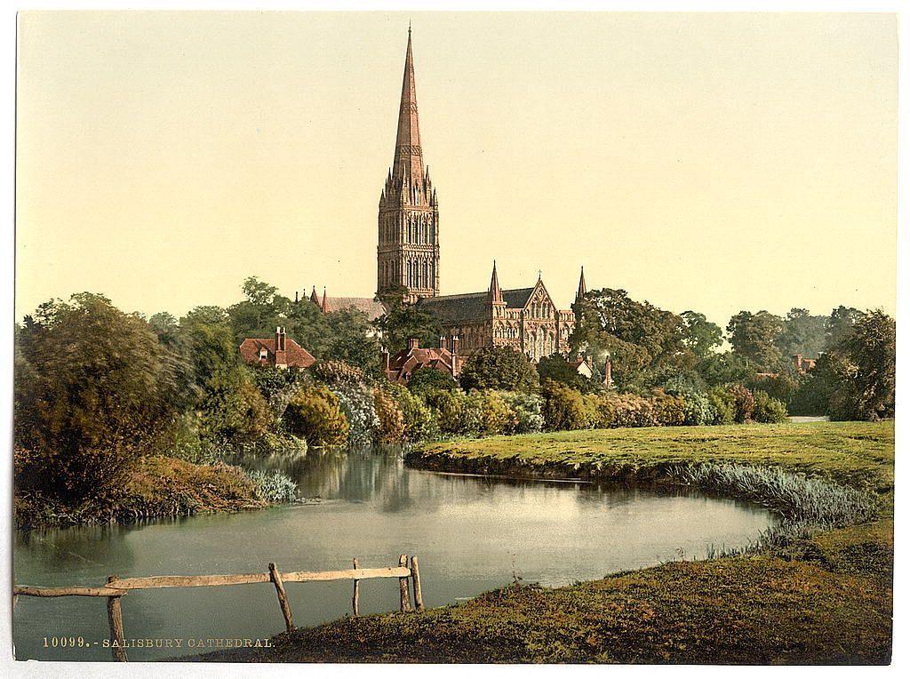 This image depicts a picturesque view of Salisbury Cathedral, located in Salisbury, England. The cathedral is characterized by its towering spire and ornate architectural details that reflect Gothic Revival style. It stands prominently against the backdrop of lush greenery, with trees framing both sides of the scene.

In front of the cathedral, there's a tranquil river running through an expanse of grassy fields. A simple wooden fence lines one edge of the waterway, suggesting human presence and use but not dominating the landscape. The overall atmosphere is serene and historic, evoking a sense of timelessness associated with such landmarks in England.

The coloration appears slightly muted, indicative that this photograph might be from late 19th or early 20th century, capturing an era when photography was still transitioning to more vibrant colors after the photographic paper process known as "photochrom" had been developed. The photo bears a cataloging number '10043 - Salisbury Cathedral' and is likely part of a collection documenting various locations in Britain during that period.

This image provides insight into how historical buildings were preserved, appreciated, and documented in their natural surroundings through photographic processes of the time.