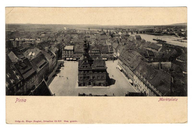 The image shows an aerial view of the market square, known as Marktplatz in German. It is captured through black and white photography which suggests that it might be a historical or vintage photo from early 20th century. The buildings around are European architectural style with multiple stories made up of wood and brick materials typical for those eras.
The town center features an open square surrounded by what appears to be merchants' shops, residential houses, and possibly administrative offices on the upper floors which is characteristic of a traditional German market area. A prominent clock tower stands in one corner, adding to the historical ambiance of the scene.
There are no people visible; this image seems more focused on showcasing architectural beauty rather than depicting daily life activities or events within the town square at that time. The distant horizon shows some hills and what might be a river flowing through the city which indicates it's near an important waterway for transportation during historical times when such towns were often centered around rivers.
At the bottom of the photo, text in German reads "Pirna" identifying this as Pirna town and mentions Marktplatz clearly marking where we're looking. Additional information like a reference to Dresden (likely indicating proximity or connection), an author's name Hugo Engler from Dresden along with s [...]