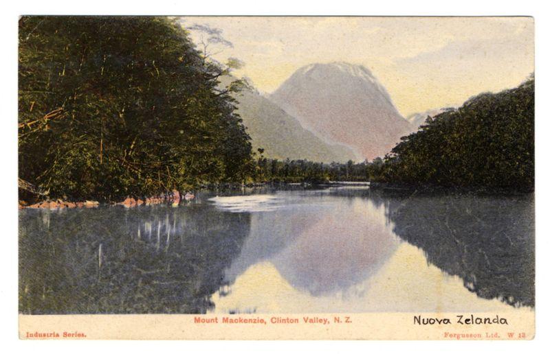This image is a vintage postcard featuring the stunning landscape of Mount Makkenzie in Clinton Valley, New Zealand. It depicts an expansive view with lush greenery on either side and reflects off calm waters that mirror the majestic mountain at its center. The sky above appears soft, suggesting early morning or late afternoon light conditions. The colors are muted yet rich, indicating a naturalistic representation typical of postcard prints from past eras.

The text "Mount Makkenzie" is prominently displayed across the bottom left portion, while "Clinton Valley N.Z." sits slightly higher up on the right side to denote location. In larger font at the top center reads "Nuova Zelanda," which translates as "New Zealand," possibly indicating that this image was part of a series highlighting various locations within New Zealand.

Additional text identifies it as an industrial photograph and references its production by Fergusson Ltd., with details on the bottom right corner specifying W.13, likely referring to its classification or edition in their collection. The overall composition is balanced, drawing attention directly towards Mount Makkenzie's reflection while providing a context of tranquility and natural beauty through the surrounding elements.

For further information about this particular postcard series, you can visit the provided link which seems to be associated wi [...]