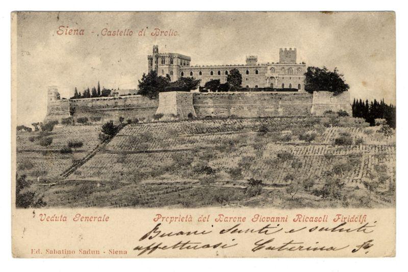 The image depicts an old black-and-white photograph of the Castello di Brolio, a historic castle located in Siena. The structure is prominently positioned on elevated terrain with walls and defensive structures visible around it. Trees are scattered across what appears to be vineyards or cultivated land extending towards the horizon. On top of the photo's printed text reads "Siena - Castello di Brolio," indicating its location and subject matter. Below this, there are more details in a script font: "Veduta Generale" which translates from Italian as 'General View,' followed by additional information about property ownership and a trip or visitation note that is too blurred to read clearly due to the image's quality.

The photograph has an aged look with signs of wear such as creases, stains, and discolorations indicative of its likely vintage nature. The bottom left corner features text in Italian: "Ed. Sabatino Sadun - Siena," suggesting it might be a published postcard or part of a collection by that publisher. On the right side of this area is another signature-like script which seems to belong to someone who has marked the photograph, possibly for identification or ownership purposes.

The overall image conveys a historical snapshot of an important landmark with personal touches added over time through annotations and signatures.