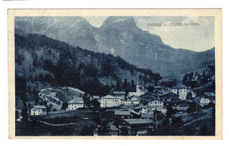 The image depicts a vintage postcard showing the village of Pianaz, located in Zoldo Alto at an elevation of approximately 1270 meters. The photograph captures a broad view of the settlement nestled within mountainous terrain. In the foreground and midground are rows of European-style buildings with pitched roofs, indicative of traditional Alpine architecture. These structures vary slightly in design but collectively convey a sense of historical continuity.

The backdrop is dominated by towering mountains that rise steeply from the village, their rugged faces hinting at the region's natural grandeur. The image has an aged appearance, characterized by faded colors and grainy texture, which suggests it may be several decades old or intentionally styled to evoke nostalgia. A prominent text overlay in a smaller font identifies "Pianaz di Zoldo (m. 1270)," indicating the village's name and its altitude.

The overall composition of the image conveys a peaceful yet remote alpine community