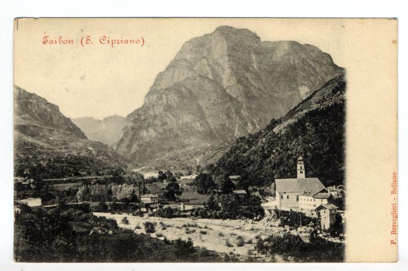 The image depicts a black and white photograph of a picturesque landscape, featuring rugged mountains in the background with dense vegetation. In the foreground, there is an expansive valley leading to a small village nestled among hills covered with trees and shrubs. The village appears quaint, with traditional European architecture including stone buildings, some with visible windows and doors.

Prominent within this settlement stands a church or chapel, distinguishable by its tower topped with a steeple that reaches towards the sky. A river cuts through the valley floor in front of the village, adding to the serene ambiance of the scene.

The photograph is framed as if it were part of an old postcard, indicated by text at the top left corner reading "Taibon (S. Cipriano)" and on the bottom right, there's a notation that states "P. Breveglieri - Belluno." This suggests that the image may have been taken or documented by someone named P. Breveglieri from Belluno.

The overall co