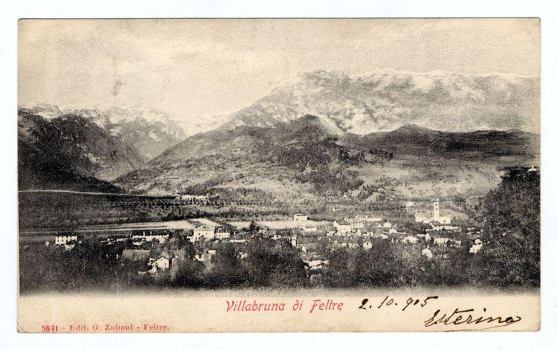 The image depicts a vintage black and white photograph of Villabruna, situated in the Feltre region. It's an old postcard with handwritten annotations that read "Villabruna di Feltre 4.10.95" indicating it was taken on October 4th, 1895 by someone named Gerolamo Zuffioli and signed off as "Eterina." The photograph captures a panoramic view of the town nestled amidst hilly landscapes with snow-capped mountains in the background.

The main focus is Villabruna itself, showing multiple buildings scattered across terraced land. A church spire stands out among these structures on what appears to be higher ground within or overlooking the village. There's an overall sense of tranquility and timelessness conveyed by this old image, capturing a snapshot in history before modern urban developments altered its scenery.

The inclusion of such historical details might suggest that it could hold significant cultural value as well - perhaps commemorating events from 1895 when Ferrero (now the fam