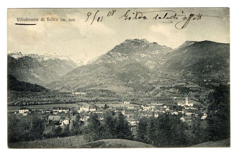 The image depicts a vintage postcard featuring an old photograph of the town of Villabruna di Feltre, situated at 365 meters above sea level. This monochromatic picture shows a panoramic view of the village nestled amidst rolling hills and mountains in the background. The prominent mountain range appears to be covered with patches of snow or bare rock faces. Below, there are clusters of buildings that form what is likely Villabruna town itself, indicating it's possibly from an earlier era given its architecture.

The photograph captures a mix of residential houses, larger structures which could serve as public facilities such as churches or administrative offices, and scattered trees interspersed throughout the landscape. The top left corner contains handwritten text that reads "Villabruna di Feltre (m. 365)" followed by dates inscribed in what appears to be a foreign script.

The postcard's borders include two signature-like imprints at the upper right, which could indicate owners