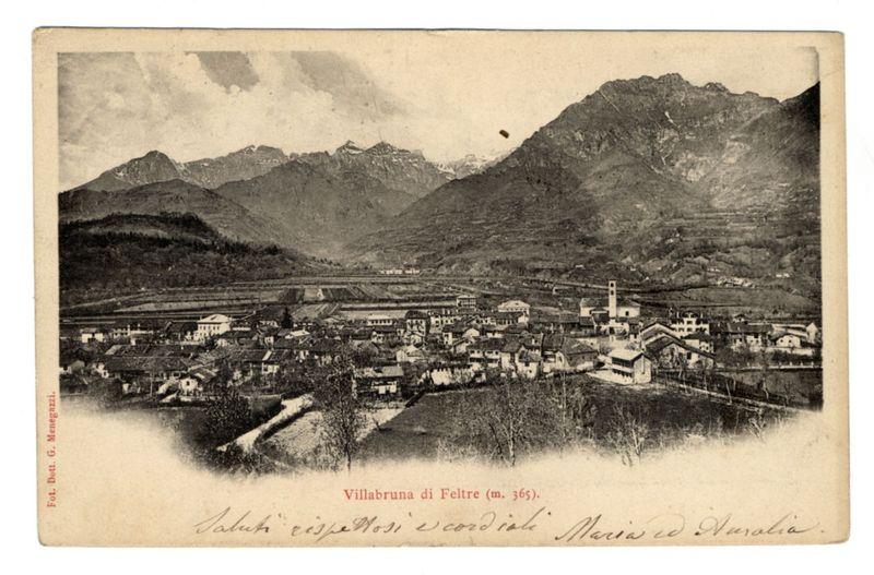 The image is a vintage black and white postcard depicting the village of Villabruna di Feltre. The photograph captures a panoramic view with mountains rising in the background, indicating a high-altitude setting possibly within an alpine region given the snow-capped peaks at higher elevations.

In the foreground, there's what appears to be a river or stream meandering through the landscape and leading into the village where numerous buildings are scattered across. These structures vary in architecture but generally suggest modest-sized homes typical of a rural community from past centuries.

The mountains have rugged terrain with steep slopes that descend down towards the settlement, suggesting challenging geographical conditions possibly conducive for agriculture like vineyards or orchards which were common in such areas during historical times.

On top right, there's text indicating "Villabruna di Feltre (m. 365)," followed by some illegible script at its base. This implies an 