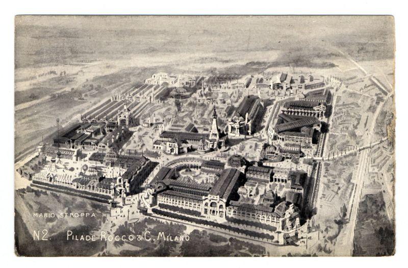 This image is a black and white aerial photograph of the Pilade Roccò & C. Milan pavilion at an exposition, presumably from around 1906 based on historical context clues such as architectural styles and photo quality. The layout showcases multiple interconnected buildings with varying roof designs, some featuring domes or spires which could indicate significant structures within a large complex, possibly industrial or commercial exhibitions of the time.

The photograph has text annotations at its bottom left corner stating "N2" followed by what appears to be the photographer's signature and company name. The overall structure is dense with architectural elements and pathways leading through it, suggesting an organized exhibition space designed for visitors' navigation and exploration. It captures a comprehensive view of urban development or infrastructure during that period.

In terms of historical context, such exposés were common in Europe around late 19th to early 20th centuries