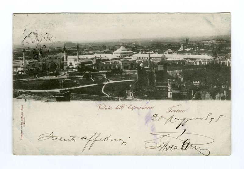 The image displays a sepia-toned photograph, possibly from the late 19th or early 20th century. It captures an expansive view of Torino (Turin), Italy, during what appears to be an exposition event in Turin with architectural structures such as buildings and monuments prominently featured within it. The text on the image indicates "Veduta del'Esposizione" which translates from Italian meaning 'View of Exposition,' hinting at a fair or exhibition taking place in Torino around 1898, as mentioned by hand-written annotation.

The photograph is accompanied by handwritten signatures and annotations that add personal sentiment to it. The paper bears the imprint "Sta Esercizio Genale" which suggests some form of general exercise routine might be associated with this image or event. There are visible signs of wear on the photograph, including creases and faded edges, giving away its age.

Overall, the photo serves as a historical snapshot from Turin's exposition period, rich in architectura