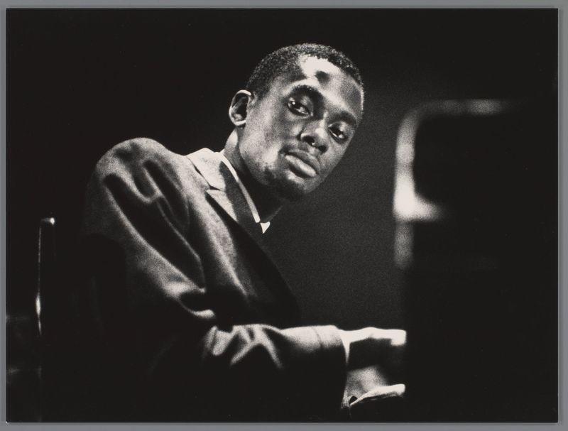 The image depicts a man immersed in playing the piano. He is captured from an angle that emphasizes his concentration and passion for music, with light highlighting his hands as they move across the keys. The monochrome tones add to the timeless quality of the photograph.

Bobby Timmons was associated with the Jazz Messengers band during this period, which performed at prestigious venues such as the Concertgebouw in Amsterdam. Ed van der Elsken is known for his evocative street photography and portraits from various cultural events across Europe. This particular image falls under a series titled 'Jazz,' showcasing notable figures within jazz music.

The date mentioned suggests that this photograph was taken on September 20, 1958. The black-and-white style of the photo aligns with van der Elsken's typical photographic approach during that era, capturing candid and emotive moments in a stark yet striking manner.