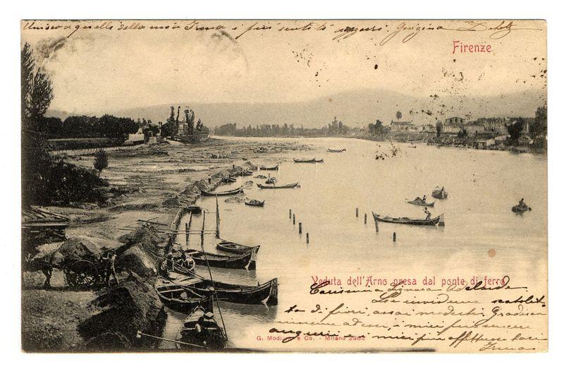 The image depicts a vintage black and white photograph, possibly from the late 19th or early 20th century. It shows a scene of the Arno River in Florence with several boats scattered across its surface. In the foreground on land, two individuals are engaged in manual labor, one operating what appears to be a cart pulled by oxen.

The photograph is embellished with handwritten script and annotations indicating it was taken from an iron bridge ("Veduta dell'Arno presa dal ponte di ferro") at sunset. The riverbanks display vegetation and distant buildings that are characteristic of the Florentine landscape, including what may be parts of Florence's city walls or fortifications.

There is a notable amount of handwriting on the image; some indicates personal notes such as "Unserer Grosse Zelle" which might refer to a family group. The names "Gioconda Da Silly," and possibly others are also written across the picture, likely representing signatures or dedications from individuals who own